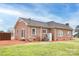Rear exterior view of brick home with a fenced yard at 2005 Douglas Rd, Lancaster, SC 28720