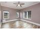 Bedroom featuring hardwood floors, three windows, and neutral walls at 2005 Douglas Rd, Lancaster, SC 28720