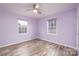 Charming bedroom with two windows, ceiling fan, and updated flooring providing ample natural light at 2005 Douglas Rd, Lancaster, SC 28720