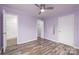 Light-filled bedroom with ceiling fan, updated flooring, and an ensuite bath and large closet at 2005 Douglas Rd, Lancaster, SC 28720