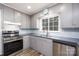 Well-equipped kitchen with stainless steel appliances and grey cabinets at 2005 Douglas Rd, Lancaster, SC 28720