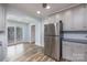Open kitchen area with stainless steel appliances and a sliding glass door at 2005 Douglas Rd, Lancaster, SC 28720