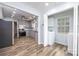 Updated kitchen with grey cabinets and stainless steel appliances, open to the dining area and laundry room at 2005 Douglas Rd, Lancaster, SC 28720