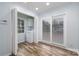 Bright laundry room with wood floors, washer, dryer and sliding glass doors to let in the sunshine at 2005 Douglas Rd, Lancaster, SC 28720