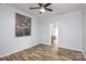 Light-blue living room featuring hardwood floors and a ceiling fan at 2005 Douglas Rd, Lancaster, SC 28720