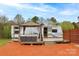 RV with a wooden deck, covered patio, outdoor seating, and a landscaped yard at 2005 Douglas Rd, Lancaster, SC 28720