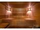 Inviting wood paneled sauna with built-in benches and soft lighting at 2005 Douglas Rd, Lancaster, SC 28720