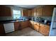 Functional kitchen featuring dark countertops, wood cabinets and essential appliances at 211 Honeycutt Rd, Troutman, NC 28166