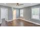 Comfortable bedroom with hardwood floors, two windows, and a ceiling fan for temperature control at 248 Kerr Nw St, Concord, NC 28025