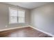 Cozy bedroom with wood floors, a large window for natural light, and neutral wall color at 248 Kerr Nw St, Concord, NC 28025