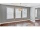 Bright dining area featuring hardwood floors, a decorative light fixture, and multiple windows at 248 Kerr Nw St, Concord, NC 28025