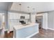 Modern kitchen with stainless steel appliances, white cabinetry, and an island with pendant lighting at 248 Kerr Nw St, Concord, NC 28025