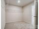 Empty closet with carpeted floors, metal shelving, and a view into the bathroom at 2639 Tillman St, Monroe, NC 28112