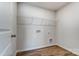A small laundry room with laminate floors and a metal storage shelf at 2639 Tillman St, Monroe, NC 28112
