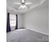 Cozy bedroom featuring neutral paint, carpet flooring, and large window with privacy blinds at 314 Sugar Creek Xing, Fort Mill, SC 29715