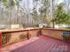 Charming red-stained deck with a railing, providing a relaxing outdoor space overlooking the backyard at 314 Sugar Creek Xing, Fort Mill, SC 29715