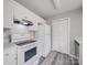 Practical kitchen with ample storage, white appliances, and contemporary flooring, designed for efficiency and ease of use at 314 Sugar Creek Xing, Fort Mill, SC 29715