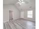 Bright living room with ceiling fan, neutral paint, and gray flooring, complemented by natural light from windows at 314 Sugar Creek Xing, Fort Mill, SC 29715