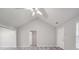 Spacious living room with vaulted ceiling, neutral paint, gray flooring, and access to bedroom and front door at 314 Sugar Creek Xing, Fort Mill, SC 29715