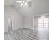 Open-concept living room with vaulted ceilings, modern gray flooring, and a sliding door to the outdoor deck at 314 Sugar Creek Xing, Fort Mill, SC 29715