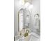 Bathroom with white vanity, gold faucet and hardware, white towels and an arched mirror at 327 Berry St, Rock Hill, SC 29732