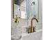 Close-up of a gold faucet and soap dispenser in a stylish bathroom at 327 Berry St, Rock Hill, SC 29732