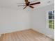 Bright, airy bedroom features neutral walls, ceiling fan and hardwood floors at 327 Berry St, Rock Hill, SC 29732