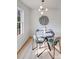 Well-lit dining area with modern light fixture, round table, and four chairs next to window at 327 Berry St, Rock Hill, SC 29732
