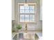 Bright kitchen featuring a stainless steel sink, gold faucet, and a window overlooking a green space at 327 Berry St, Rock Hill, SC 29732