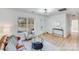 Well-lit living room with a combination of brown and white furniture complemented by decor and wood-look flooring at 327 Berry St, Rock Hill, SC 29732