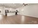 Open-concept living area boasts hardwood floors and a modern kitchen with stainless steel appliances at 3508 Narrow Ln, Charlotte, NC 28215