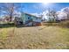 Exterior view of home showcasing backyard with wooden stairs and deck, offering a private outdoor space at 36 Brookline St, Great Falls, SC 29055