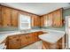 Functional kitchen with classic wood cabinets, ample counter space, and a double sink, ready for culinary creations at 36 Brookline St, Great Falls, SC 29055