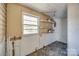 Practical utility room with storage shelves and a window, providing functionality and organization at 36 Brookline St, Great Falls, SC 29055