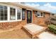 Close-up of a brick home entrance with a decorative oval-window door and manicured shrubs at 4014 Linwood Rd, Gastonia, NC 28052