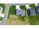 Birds eye view of a house featuring a gray roof, manicured lawn, and circular driveway at 4227 Holly Ne Cir, Conover, NC 28613