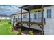 Elevated deck features dark brown flooring, black metal railings, and ceiling fan for outdoor enjoyment at 4227 Holly Ne Cir, Conover, NC 28613