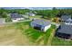Aerial view of an expansive backyard with a patio, lush green grass, and mature trees at 4227 Holly Ne Cir, Conover, NC 28613