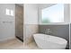 Bathroom features a soaking tub, a walk-in shower, and a window at 4227 Holly Ne Cir, Conover, NC 28613