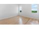 A naturally lit bedroom featuring hardwood flooring, white trim, and double windows at 4227 Holly Ne Cir, Conover, NC 28613