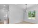 Dining room with white walls and trim, hardwood floors, and modern chandelier at 4227 Holly Ne Cir, Conover, NC 28613