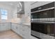 Modern kitchen with stainless steel appliances, white cabinets, stone backsplash, and hardwood floors at 4227 Holly Ne Cir, Conover, NC 28613