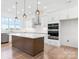 Modern kitchen with a large island, stainless steel appliances, and pendant lighting at 4227 Holly Ne Cir, Conover, NC 28613