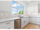 Bright kitchen features white cabinets, stainless steel appliances, quartz counters, and a large window at 4227 Holly Ne Cir, Conover, NC 28613