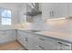 Kitchen with stainless steel appliances, white cabinets, stone backsplash, and hardwood floors at 4227 Holly Ne Cir, Conover, NC 28613