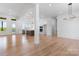 Open-concept living room featuring hardwood floors and views to the kitchen at 4227 Holly Ne Cir, Conover, NC 28613