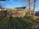 Fenced backyard offers privacy for outdoor enjoyment, featuring grass and mature trees on a sunny day at 446 Windsor Ln, Statesville, NC 28677