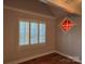 Bedroom view showcasing hardwood floors, window shutters, and decorative stained glass at 446 Windsor Ln, Statesville, NC 28677