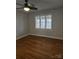 Bright bedroom featuring a ceiling fan, hardwood floors and window with blinds at 446 Windsor Ln, Statesville, NC 28677