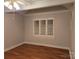 Bedroom featuring neutral walls, hardwood floors, shuttered window, and a ceiling fan at 446 Windsor Ln, Statesville, NC 28677